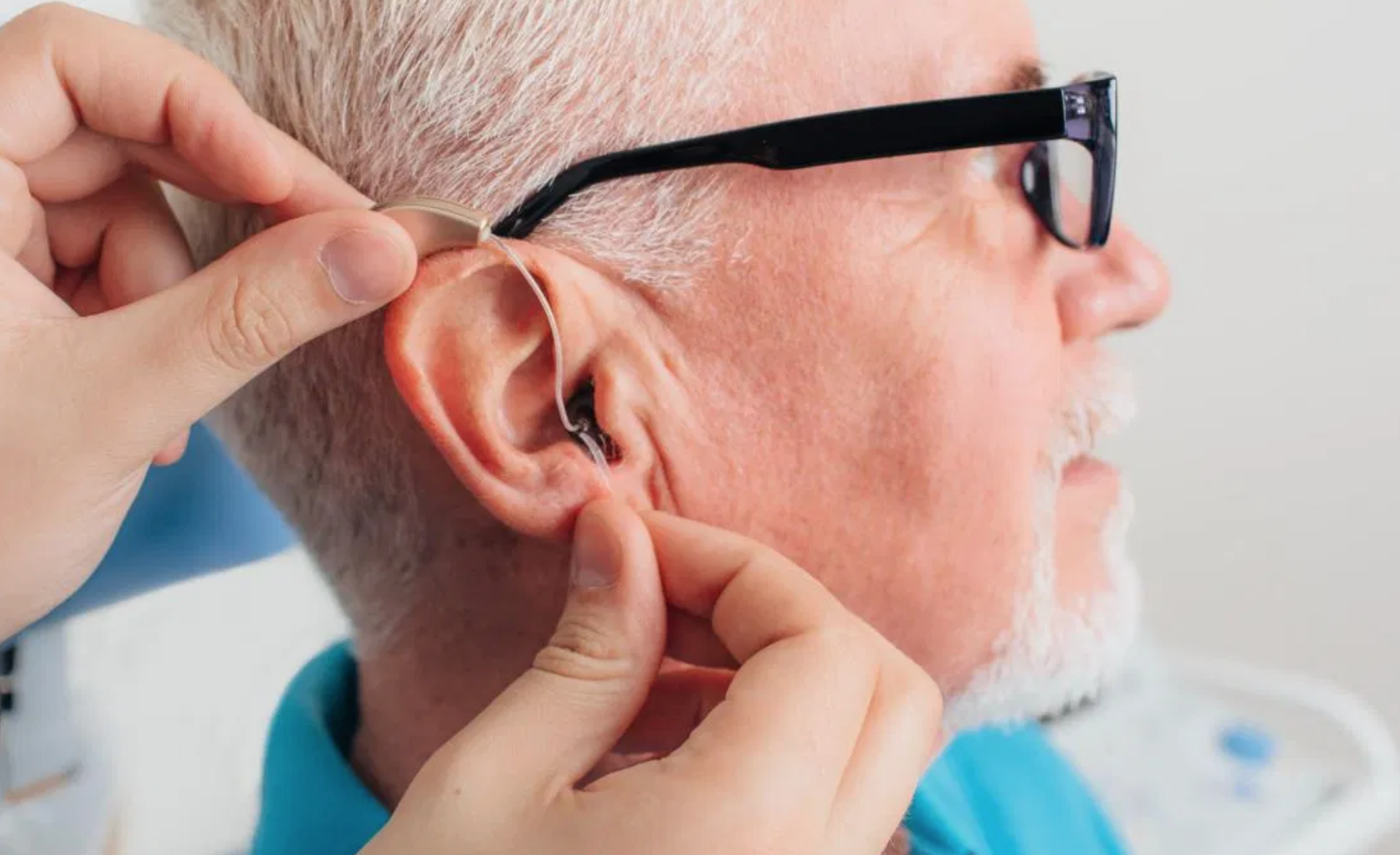 Man getting fitted with hearing aid