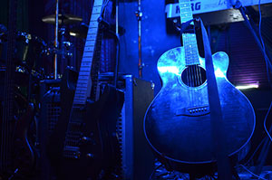 Picture of a guitar with blue lighting