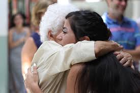 girl hugging her grandmother