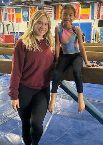 Olivia with her gymnastics coach