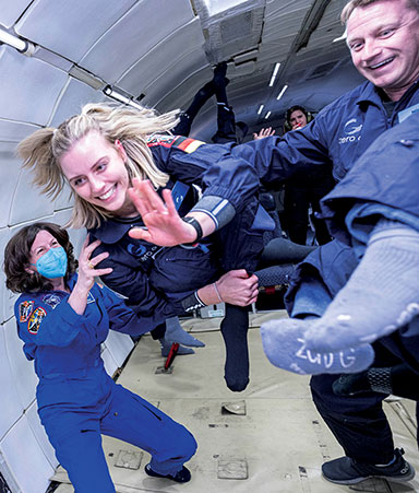 Members of the AstroAccess team floating in space